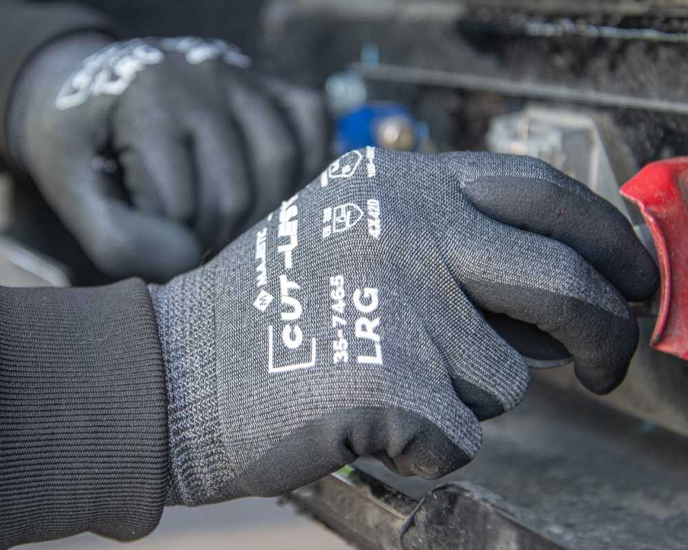 Worker opening a door using Majestic's impact-resistant Concussion Gloves